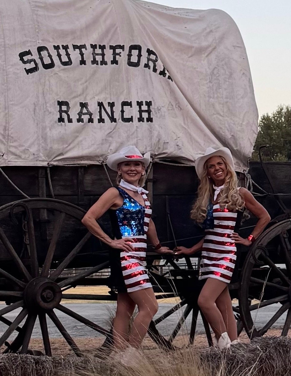 Sassafras dancers posing by the Southfork Ranch wagon